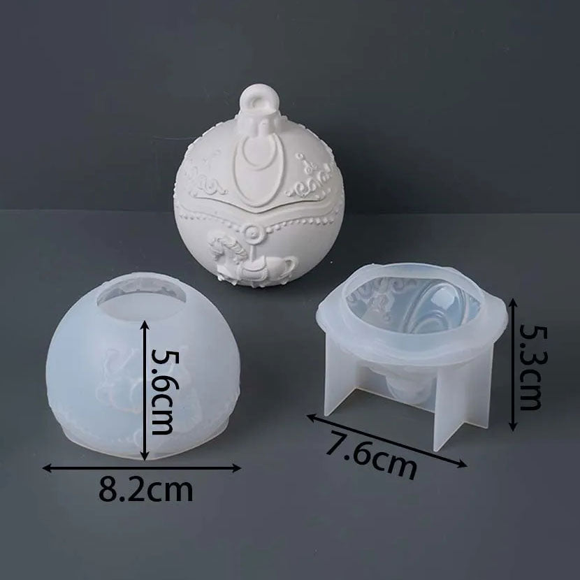 Three translucent white silicone molds shown on a dark gray background with overlaid dimension arrows and labels: a round ornament-shaped mold at top center, a round cup mold at lower left labeled 5.6cm height and 8.
