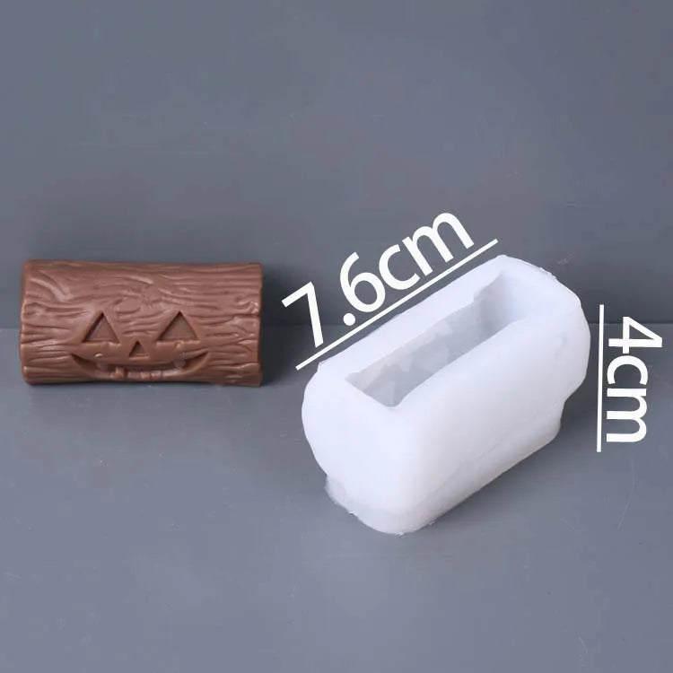 A small brown pumpkin jack-o'-lantern mold next to a white rectangular silicone mold, with overlaid dimension labels showing 7.6cm and 4cm, on a gray background.