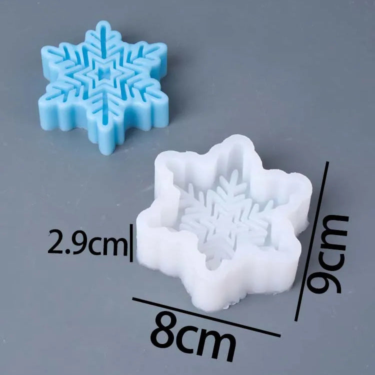 Two snowflake-shaped molds on a gray background, one light blue and one white, with dimension labels showing 8cm by 9cm and text reading 'Molds Weight:74g'.